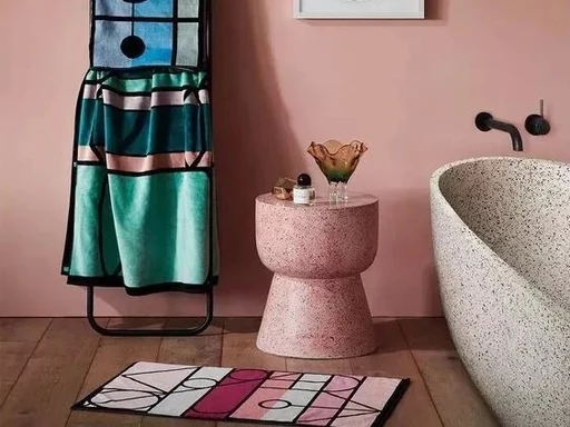 Pastel pink inorganic terrazzo stool side table, speckled terrazzo freestanding bathtub, modern bathroom styling